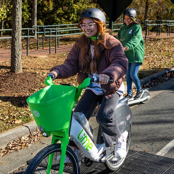 students ride Lime bikes and e-scooters