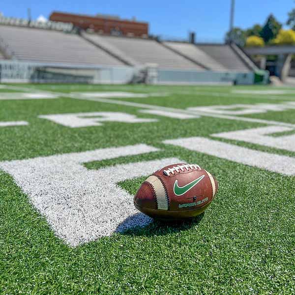 A football sitting on the field of Jerry Richardson Stadium.