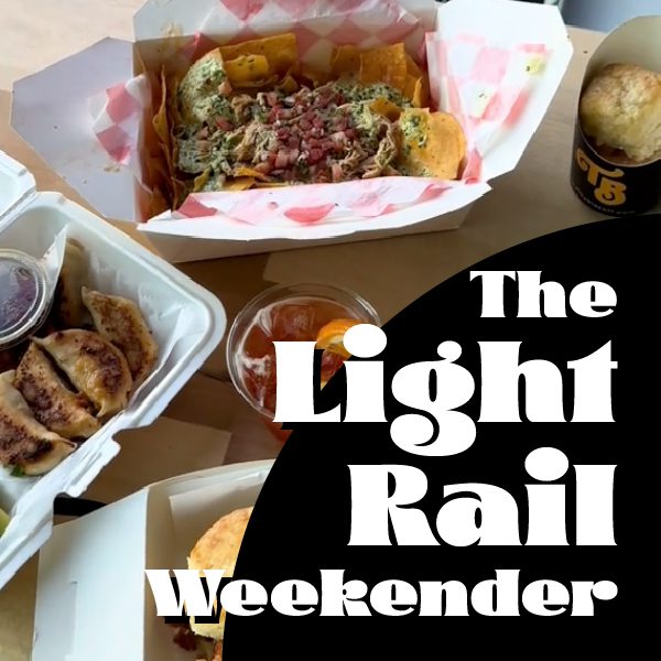 several take-out containers and baskets full of food sit on a table outside, bold text in the corner reads "The Light Rail Weekender"