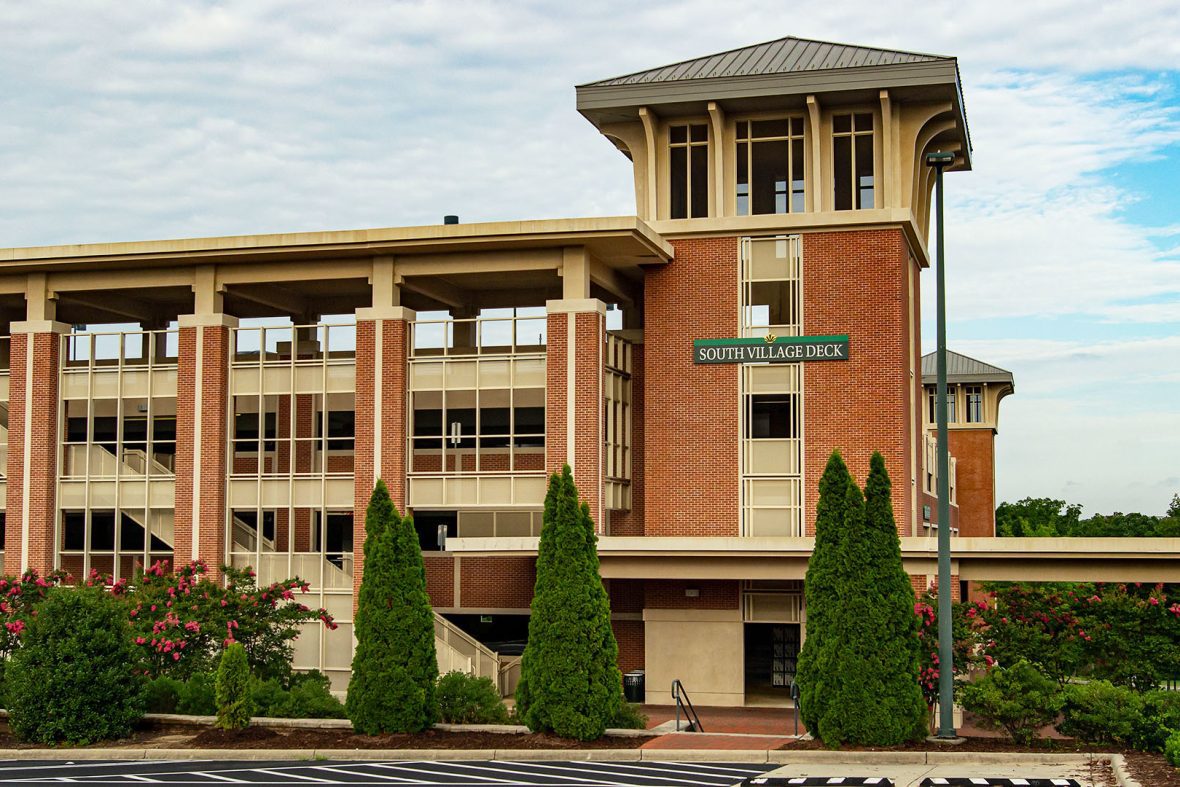 Parking building with stairs and a South Village Deck sign