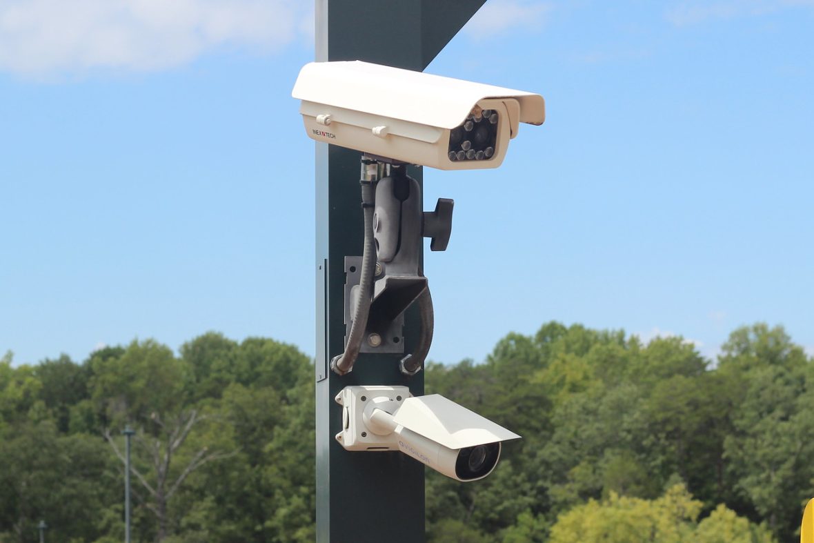 Cameras mounted on pole next to parking entrance