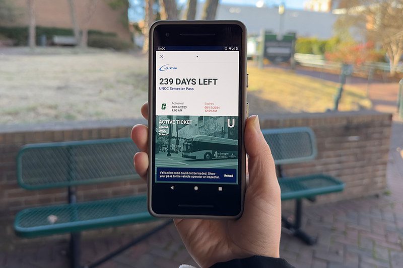 Hand holding up phone showing CATS pass with active ticket.