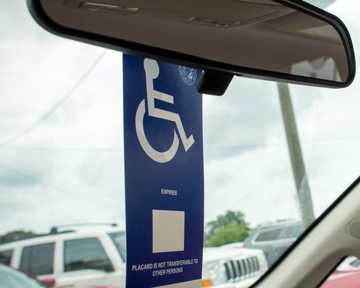 disability placard hanging from a car's rear view mirror