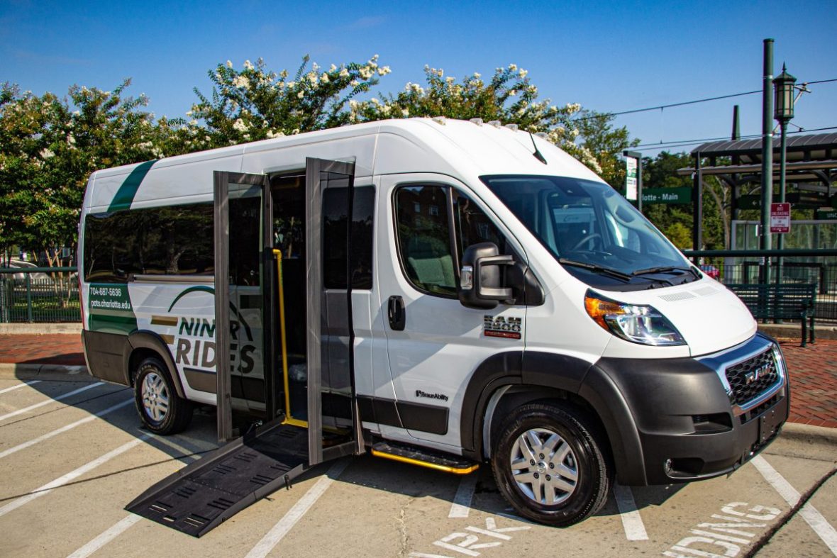 Small paratransit shuttle van with a ramp sticking out
